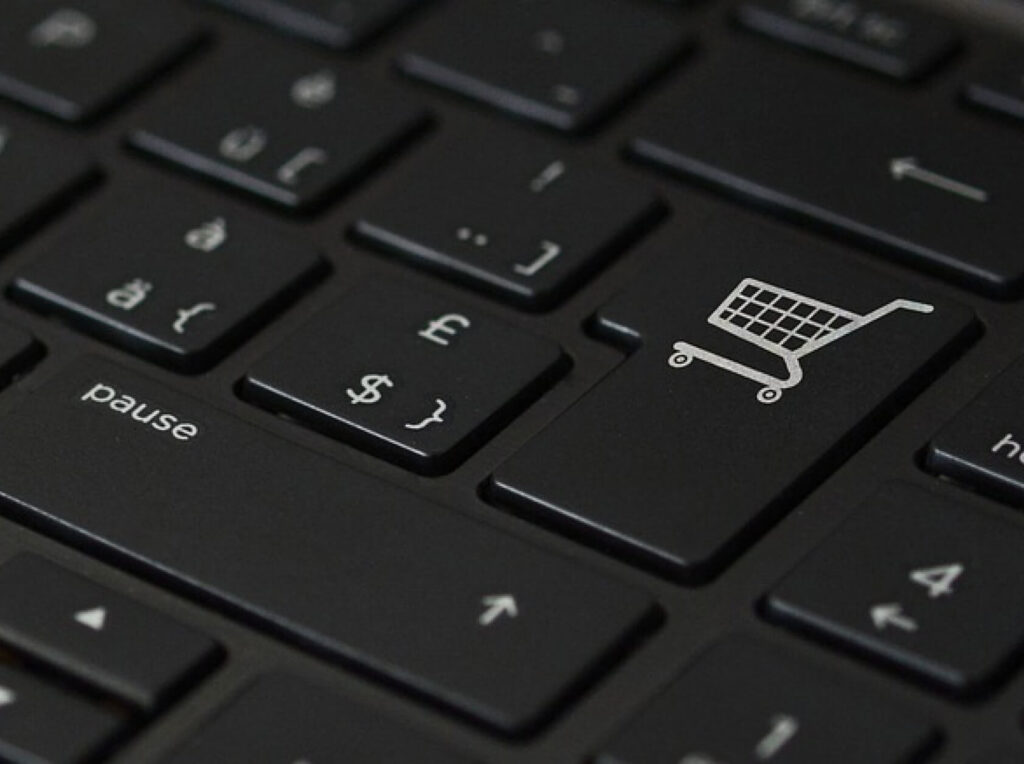 black keyboard with the Enter key's logo replaced with a shopping cart, representing ecommerce