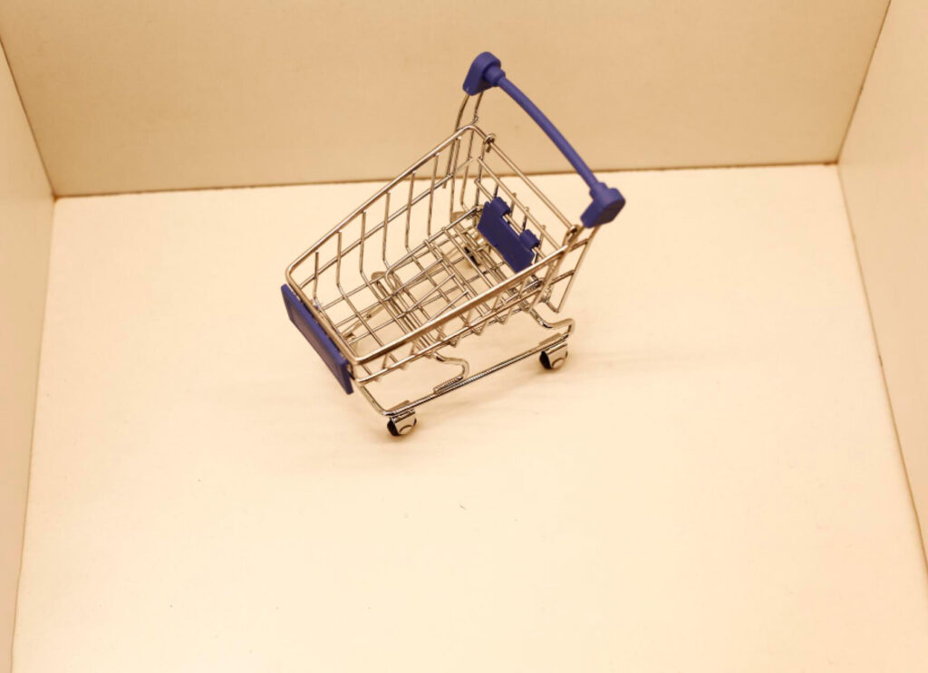 a miniature shopping cart inside a little box 