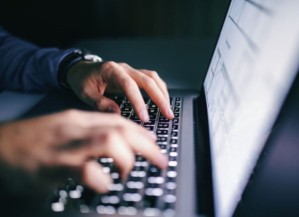 cybersecurity employee working on a laptop