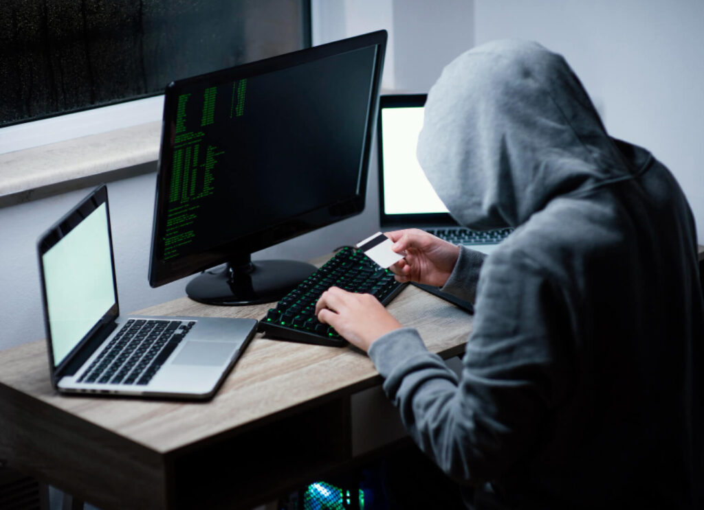 a hooded hacker performing a cyberattack