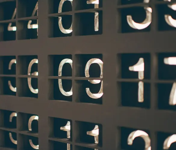 close-up view of a backlit numerical display, showing various numbers such as "4", "0", "9", and "1" arranged in a grid-like structure