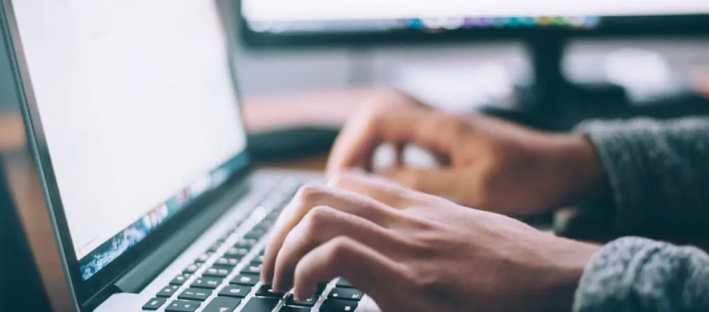 man typing on a computer