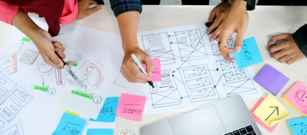 a team of people drawing a web design mockup for a WordPress site