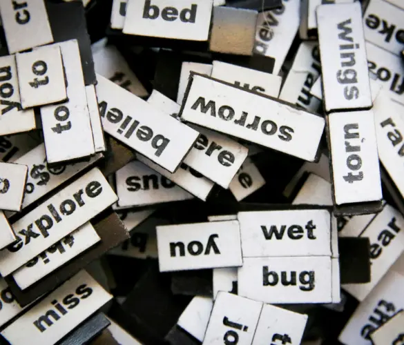 several cutouts of words on top of each other