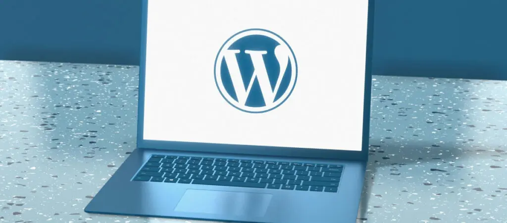 A laptop with a WordPress logo on the screen