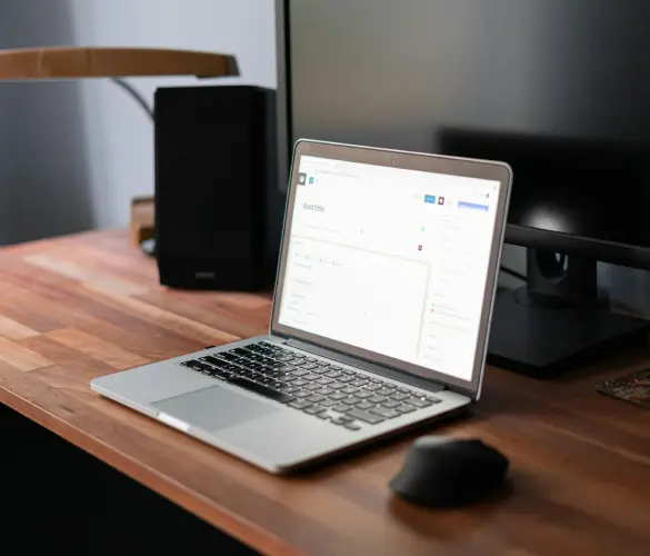 a Mac laptop over a table running the WordPress editor