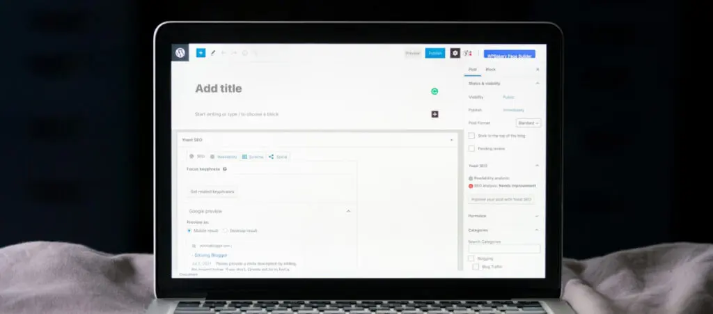 a laptop over a bed or sheets. The screen displays the WordPress Gutenberg editor