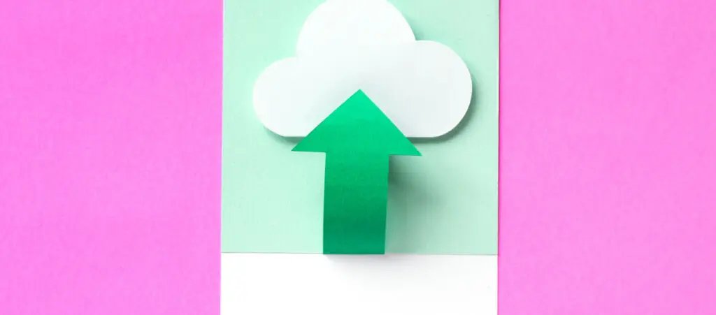 A green arrow pointing up into a cloud over a pink background. Everything is made out of cardboard