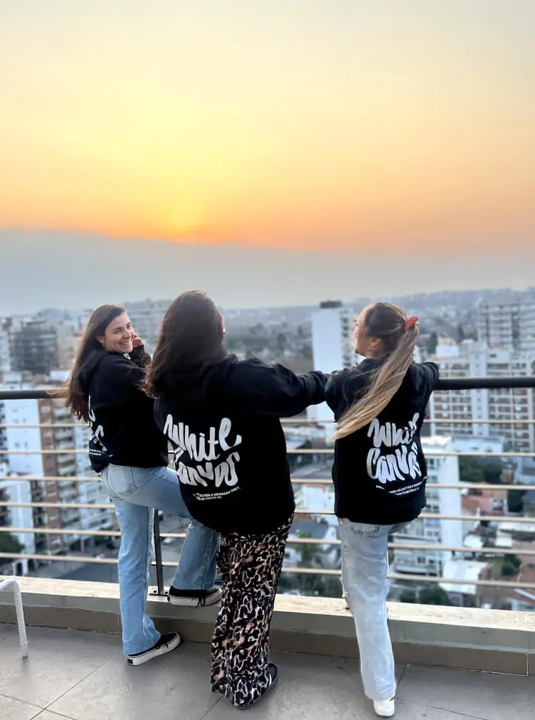 3 girls wearing a White Canvas hoodie