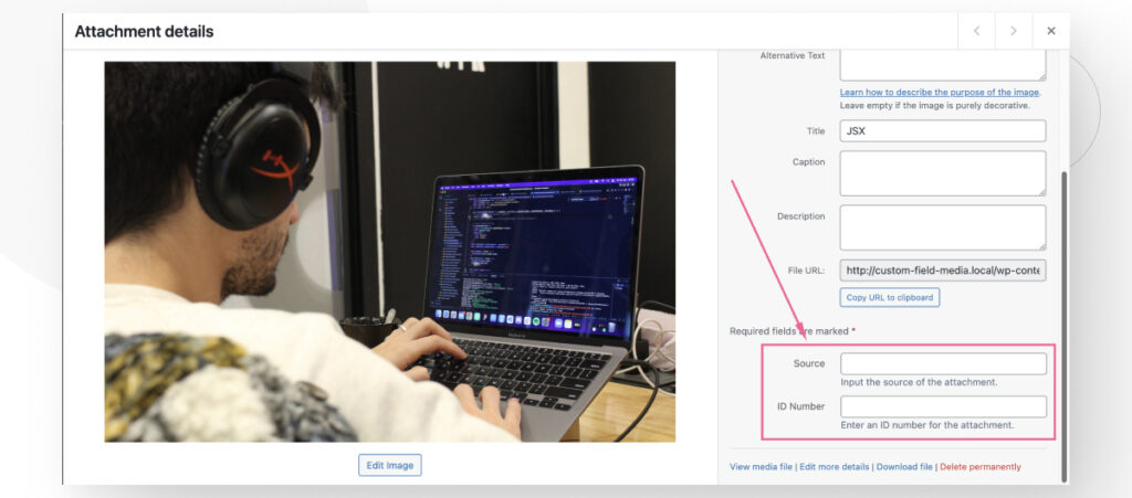 The WordPress Media Library as seen from the admin dashboard. An arrow points to the newly created custom fields for inputting the source of the media file and an ID number.