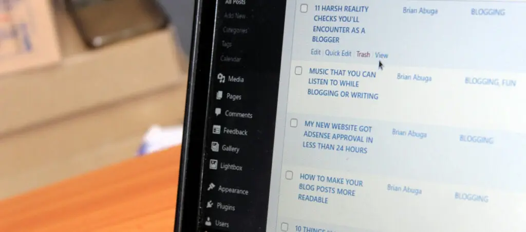 A closeup of a laptop screen displaying a list of WordPress posts as seen from the admin dashboard