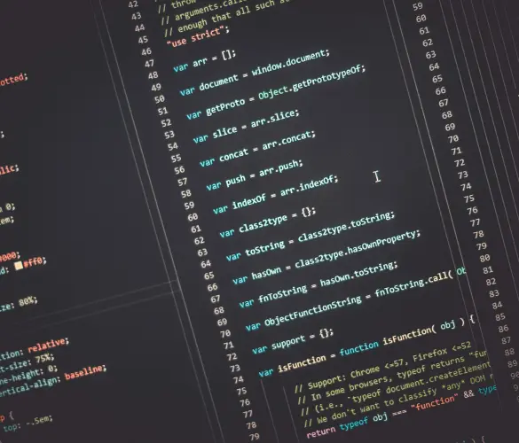 colorful JavaScript, CSS, and HTML code over a black computer screen background