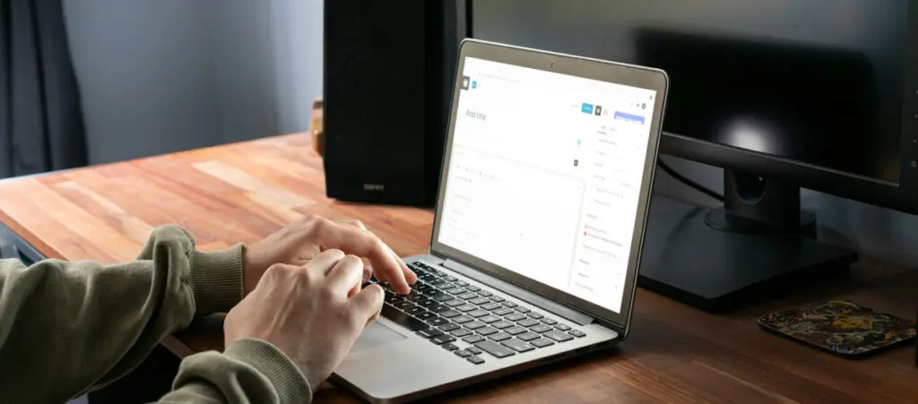 over the shoulder view of someone using a Mac to edit a page or post using WordPress's Gutenberg editor