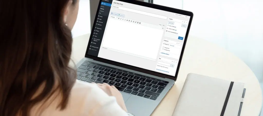 over the shoulder view of someone using WordPress on a laptop