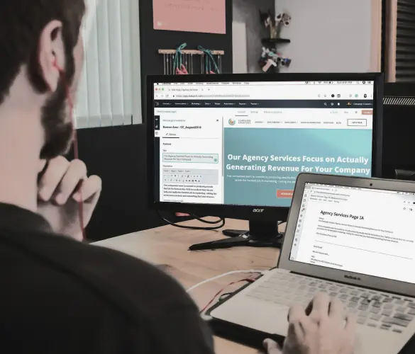 a web developer inspecting a website in his laptop