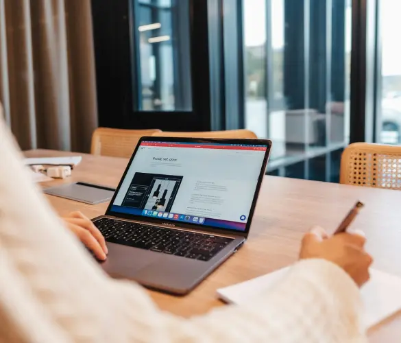 an office worker using a laptop on a table