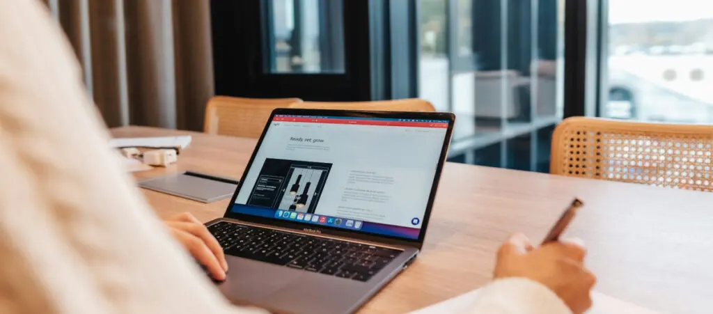 an office worker using a laptop on a table