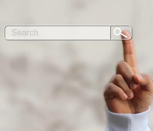 a search engine bar, with a hand comning into frame to place its index finger directly in the "Search" button