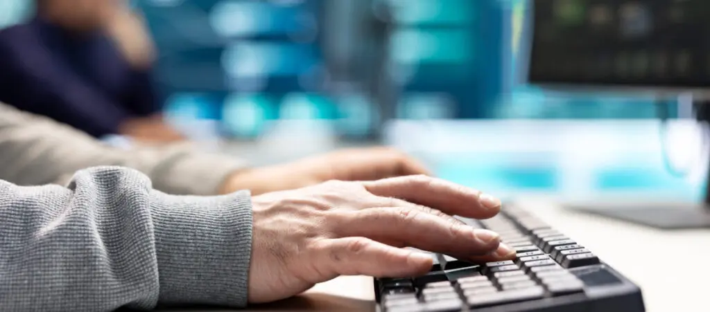 a closeup of someone using a keyboard at work