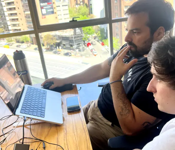 two WordPress developers staring at a screen while working together