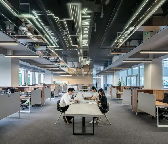 wide shot of a man and a woman sitting on an office desk