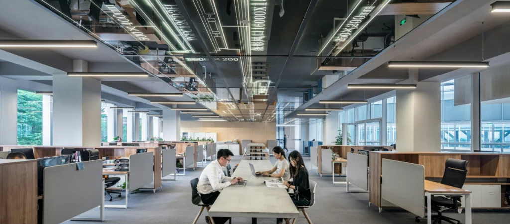 wide shot of a man and a woman sitting on an office desk