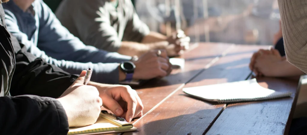 several people sitting together around a table discussing business