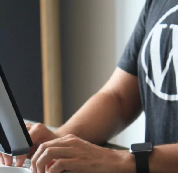 Man with a WordPress t-shirt coding