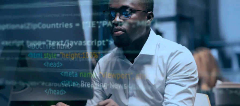 man coding with code on the screen