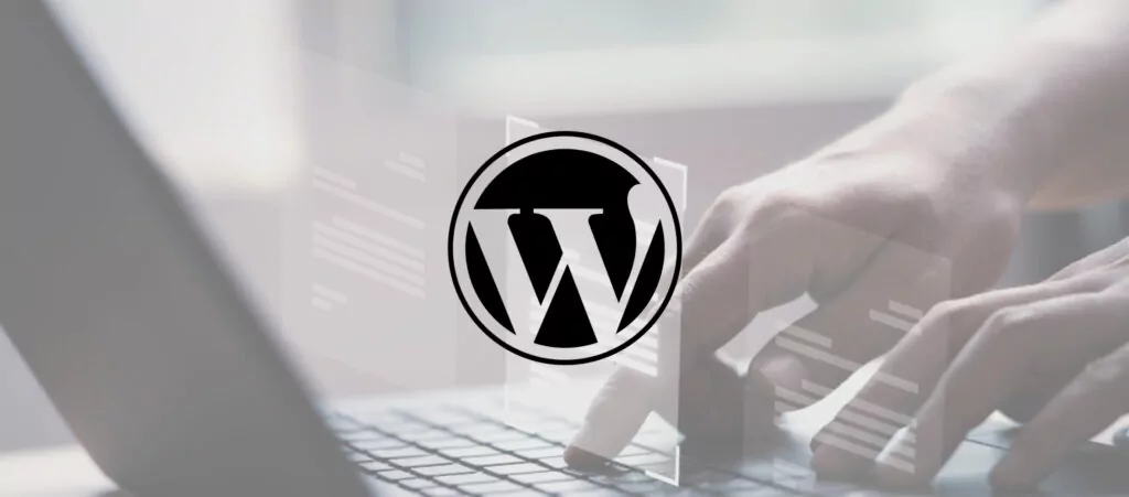 person using a laptop with a wordpress logo as a watermark